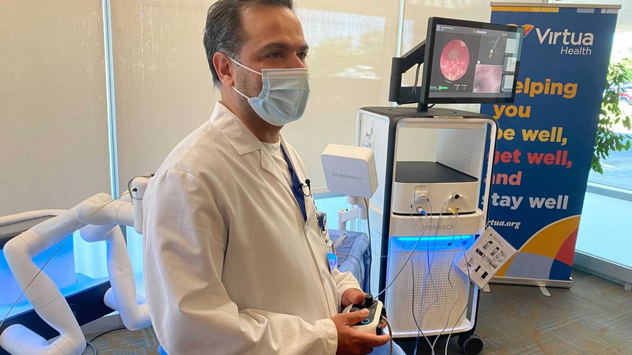 Dr. Syed Riaz, interventional pulmonologist at Virtua Health in Marlton, New Jersey, operates a robot that can navigate the lungs, using an Xbox-style controller.