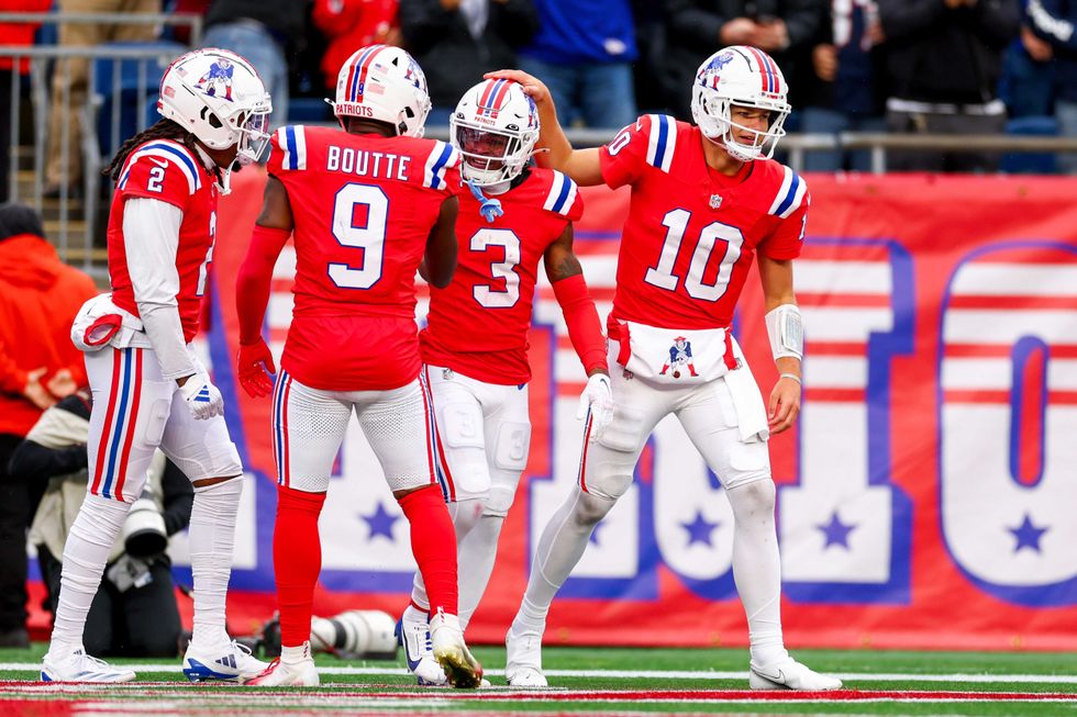 Drake Maye #10 of the New England Patriots celebrates with teammate DeMario Douglas #3 after a touchdown during the fourth quarter against the Houston Texans at Gillette Stadium on October 13, 2024 in Foxborough, Massachusetts.