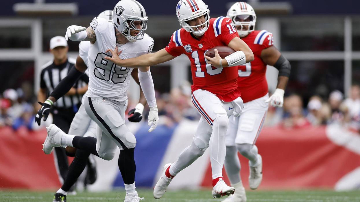 Drake Maye #10 of the New England Patriots runs against Maxx Crosby #98 of the Las Vegas Raiders during the first quarter at Gillette Stadium on October 11, 2026 in Foxborough, Massachusetts.