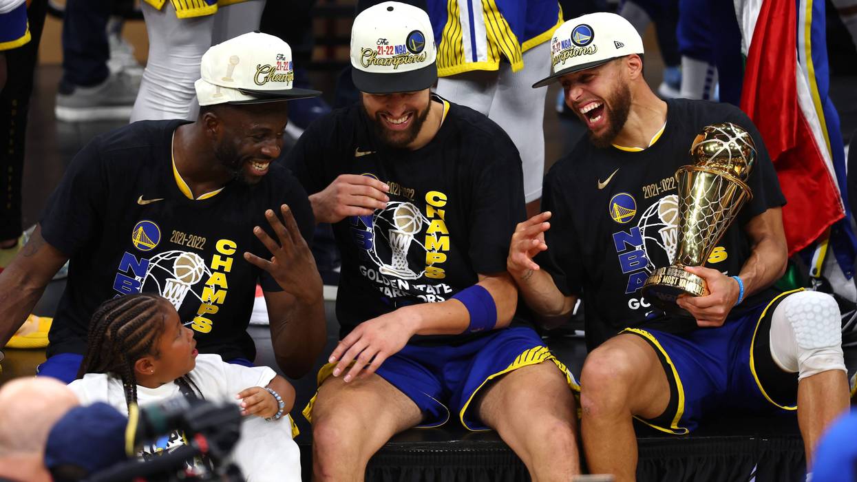 Draymond Green #23, Klay Thompson #11 and Stephen Curry #30 of the Golden State Warriors laugh together after defeating the Boston Celtics 103-90 in Game Six of the 2022 NBA Finals at TD Garden on June 16, 2022 in Boston, Massachusetts.