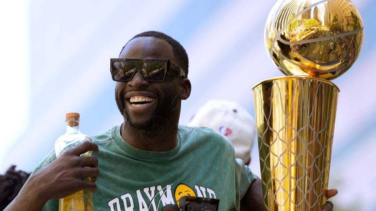 Draymond Green #23 of the Golden State Warriors celebrates with the NBA Championship Trophy during the Golden State Warriors Victory Parade on June 20, 2022 in San Francisco, California.