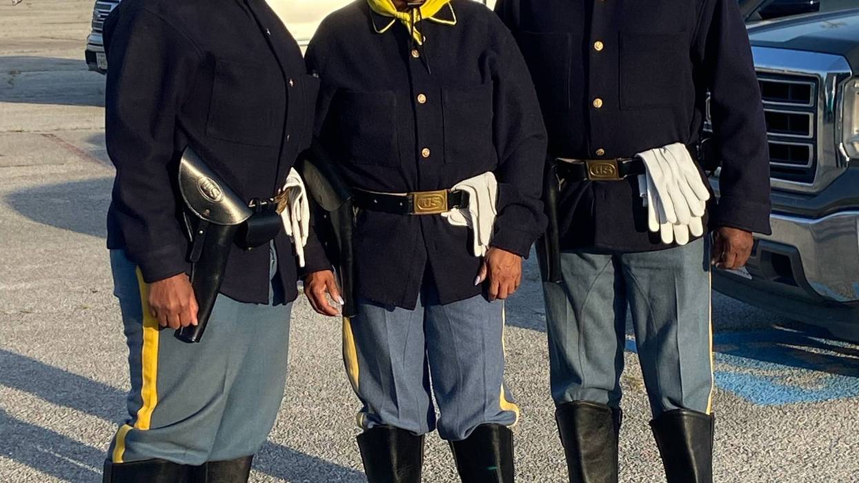 Dressed in tribute to the Buffalo Soldiers, participants in Fort Worth’s Juneteenth Freedom Walk pose outside Farrington Field — honoring the legacy of Black service members who fought for freedom long before it was fully granted.