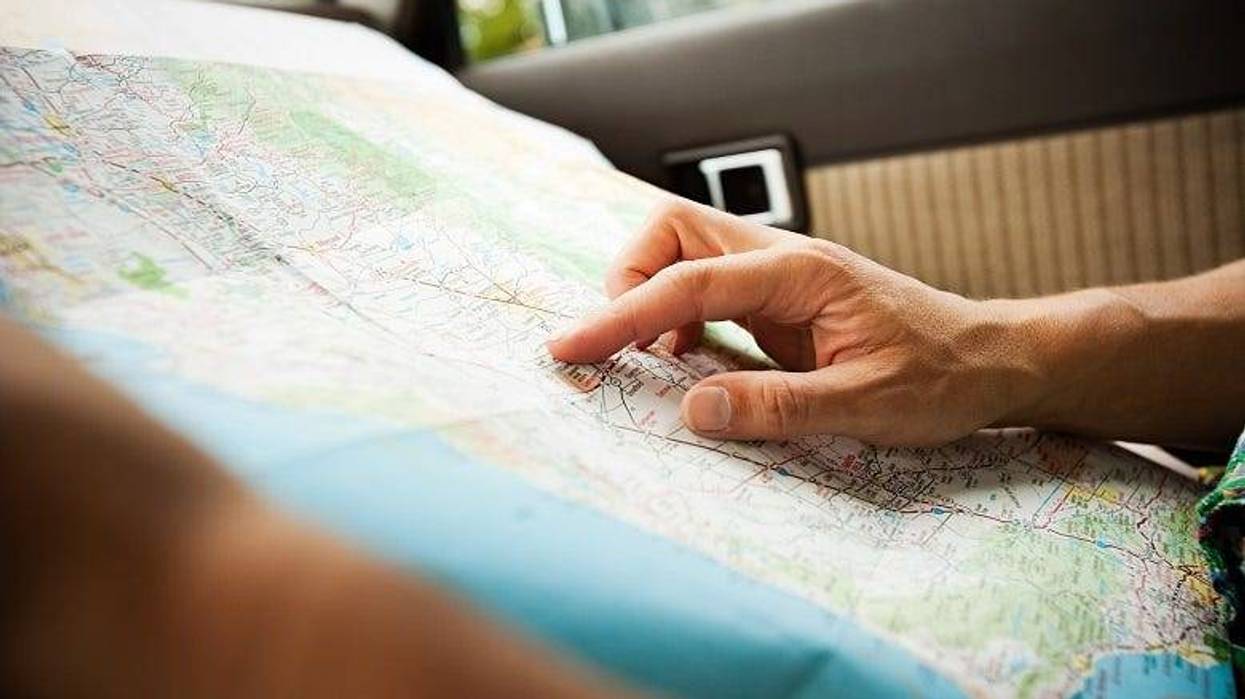 driver looking at map in car