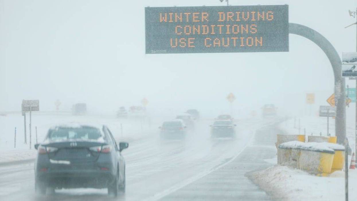 Drivers make their way along slick and snowy roads on November 26, 2019 in Denver, Colorado.