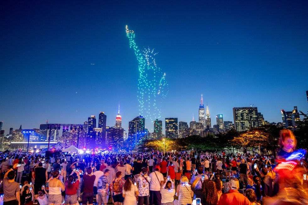 Drones perform a light show in the form of the Statue of Liberty before the Macy