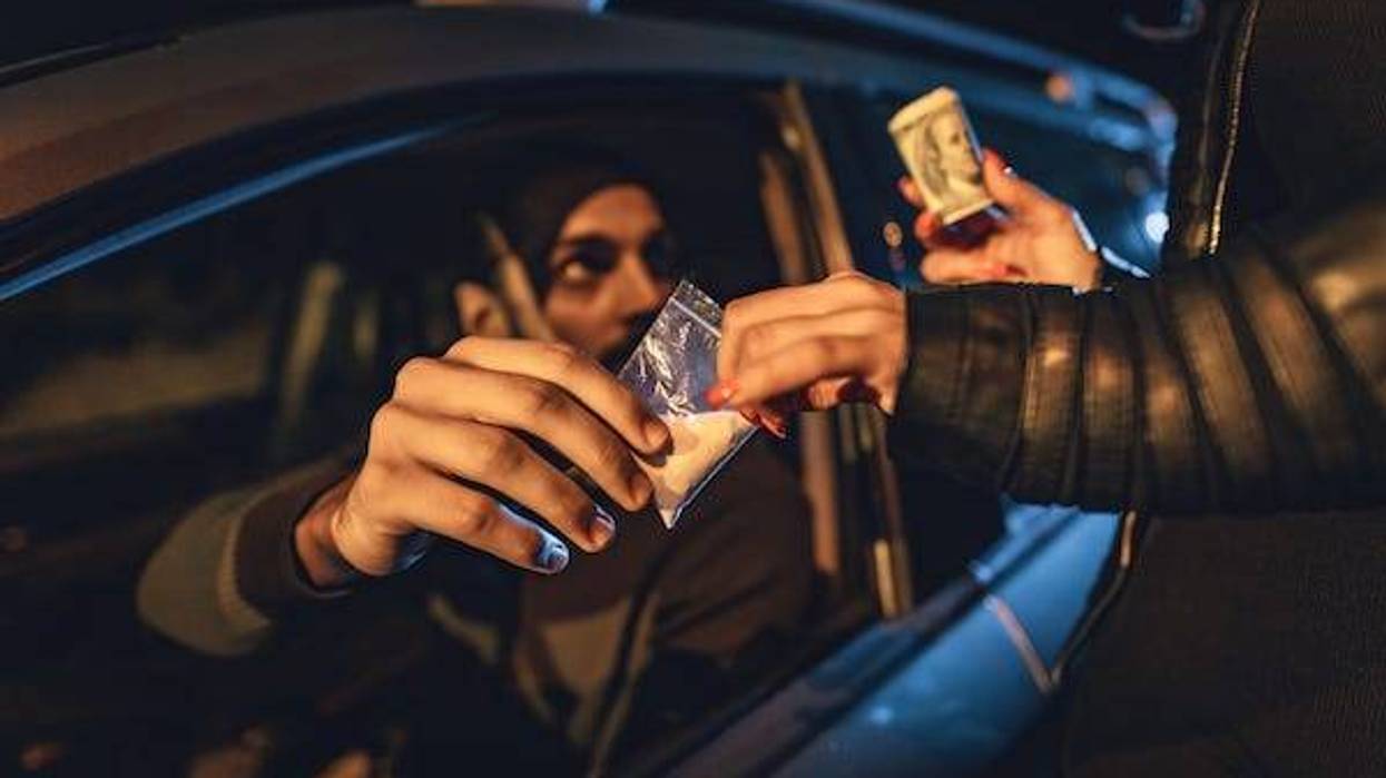 Drug deal between woman and man sitting in car