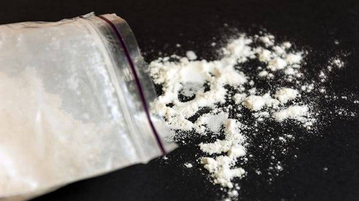 Drugs in a plastic bag on black background.