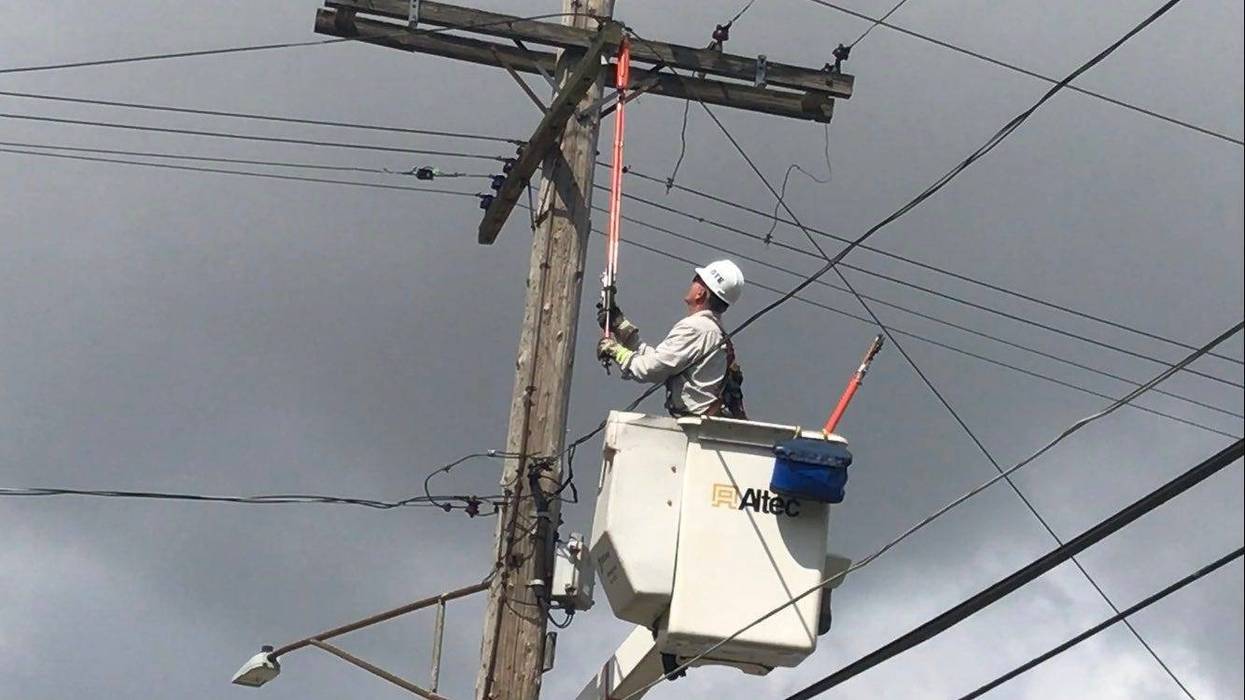 DTE employee working to restore power