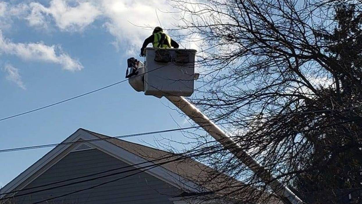 DTE worker works on a power line in West Bloomfield