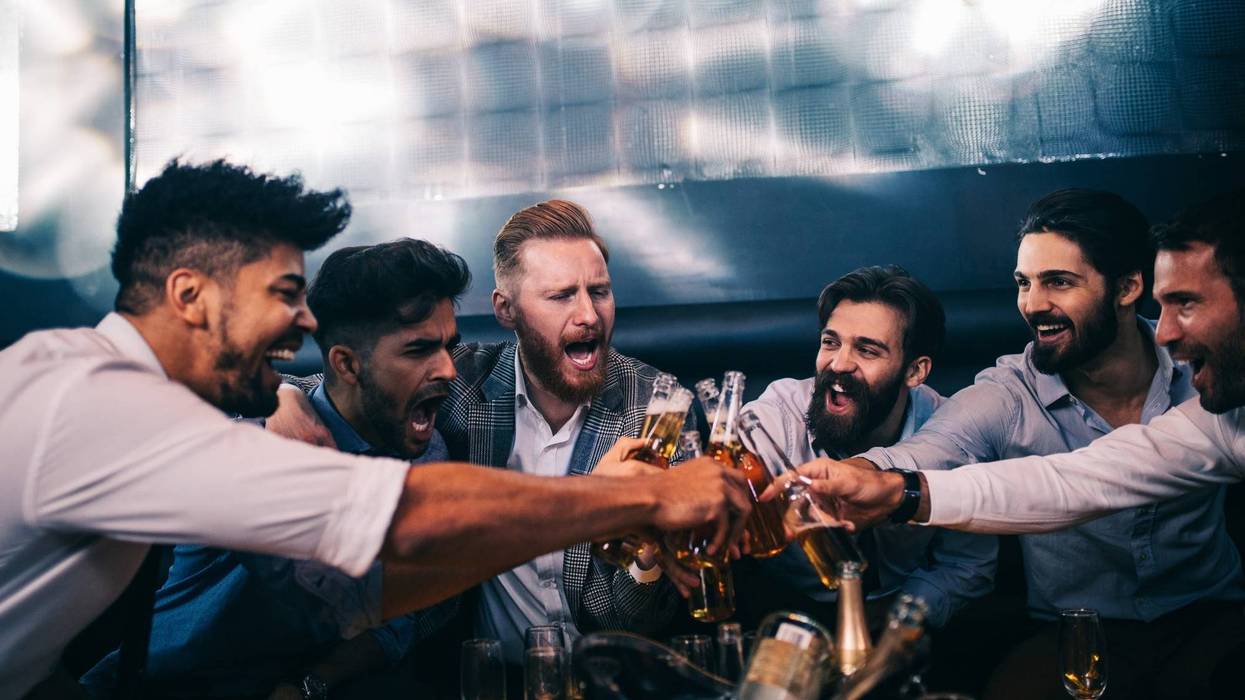 Dudes cheering beers at a bachelor party