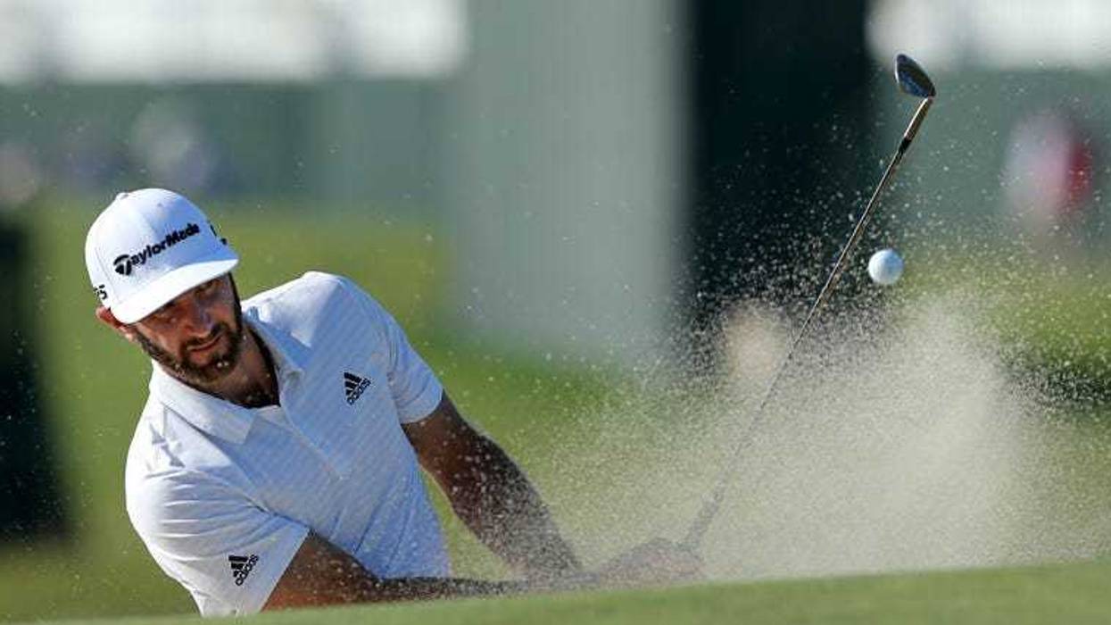 Dustin Johnson hits out of a sand trap onto the second green during Tuesday's practice round for the 118th U.S. Open golf tournament on June 12, 2018, at Shinnecock Hills in Southampton.