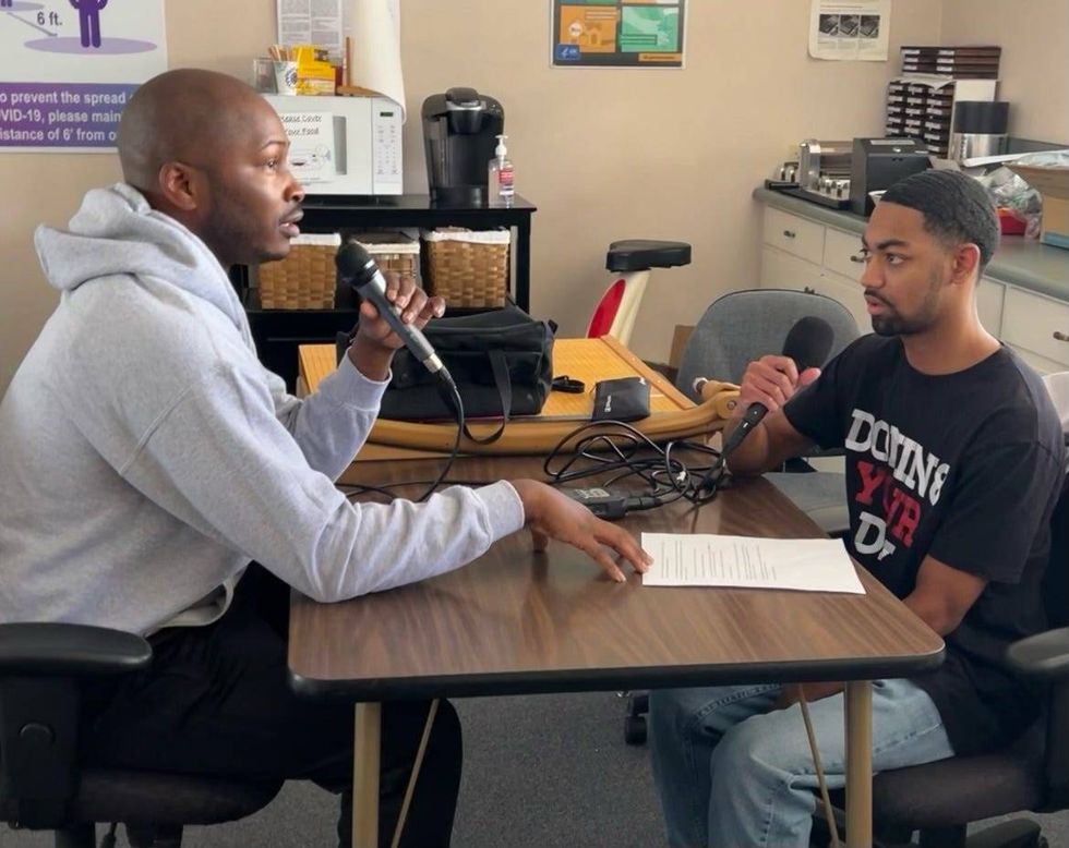 Dwight Taylor Sr. (left) speaking with KCBS Radio
