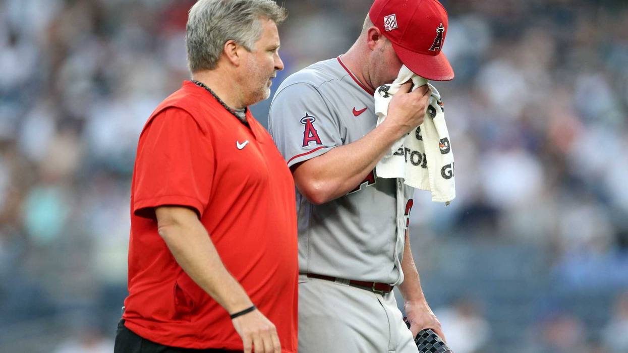 Dylan Bundy #37 of the Los Angeles Angels is teken off the field after getting sick during the game between the Los Angeles Angels and the New York Yankees at Yankee Stadium on Monday, June 28, 2021.