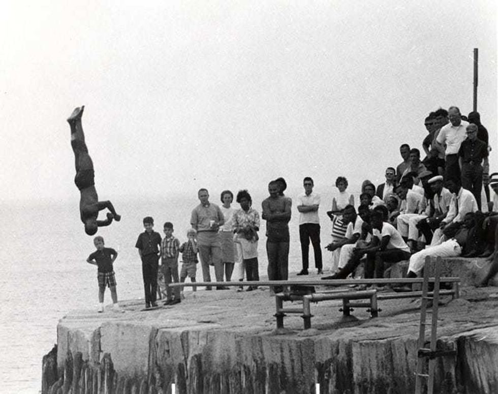 Earlier Chicago Air and Water Shows featured a diving competition. Here, a diver leaps off of a diving board into Lake Michigan.