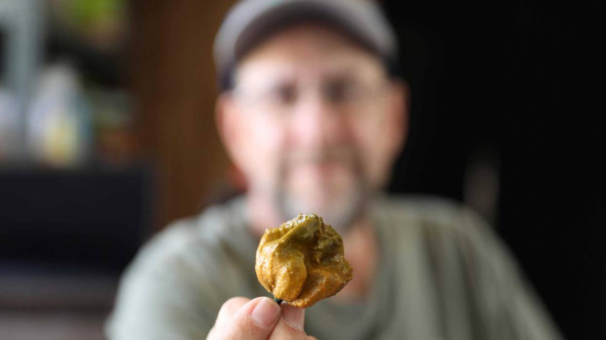 Ed Currie holds up one of his Pepper X peppers on Tuesday, Oct. 10, 2023, in Fort Mill, S.C. The pepper is now the hottest pepper variety in the world according to the Guinness Book of World Records.