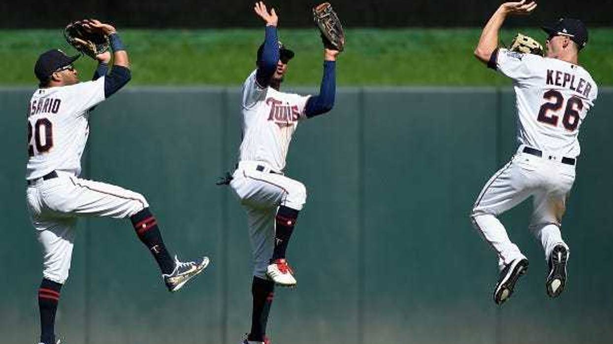 Eddie Rosario #20, Byron Buxton #25 and Max Kepler #26 of the Minnesota Twins celebrate defeating the Milwaukee Brewers 3-1 after the interleague game on May 20, 2018 at Target Field in Minneapolis, Minnesota.