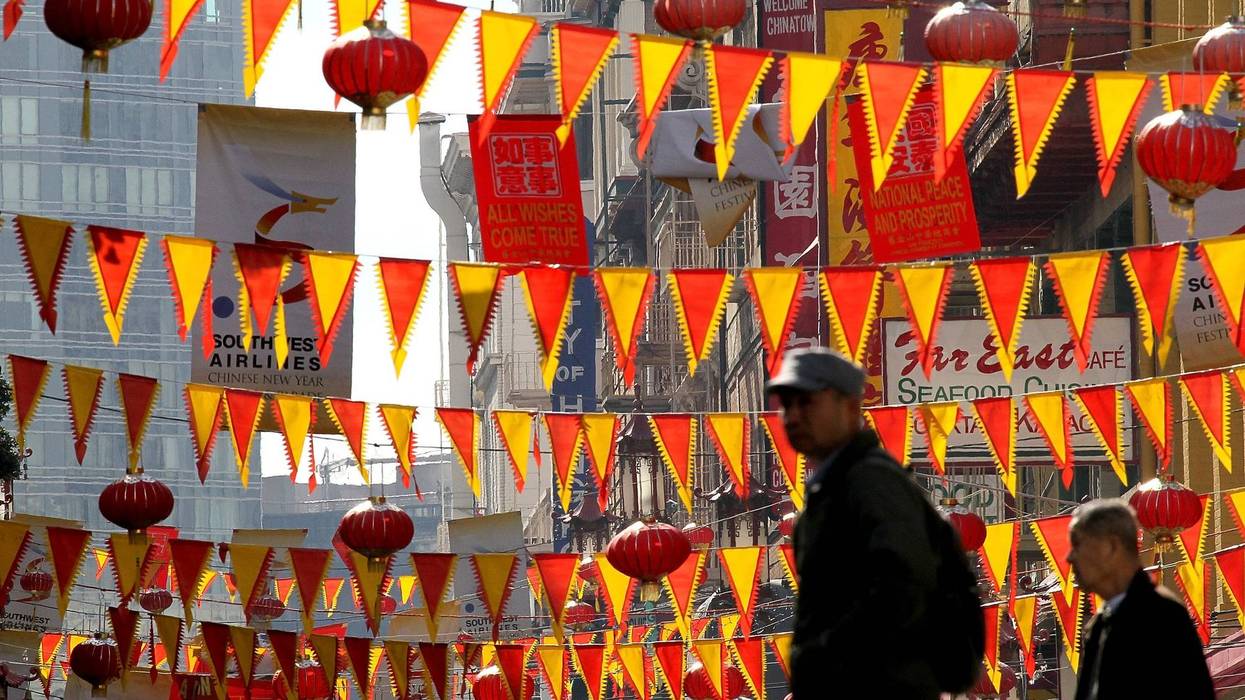 edestrians walk by red and yellow banners that are strung across Grant Street for Chinese New Year in San Francisco's Chinatown district on February 3, 2011