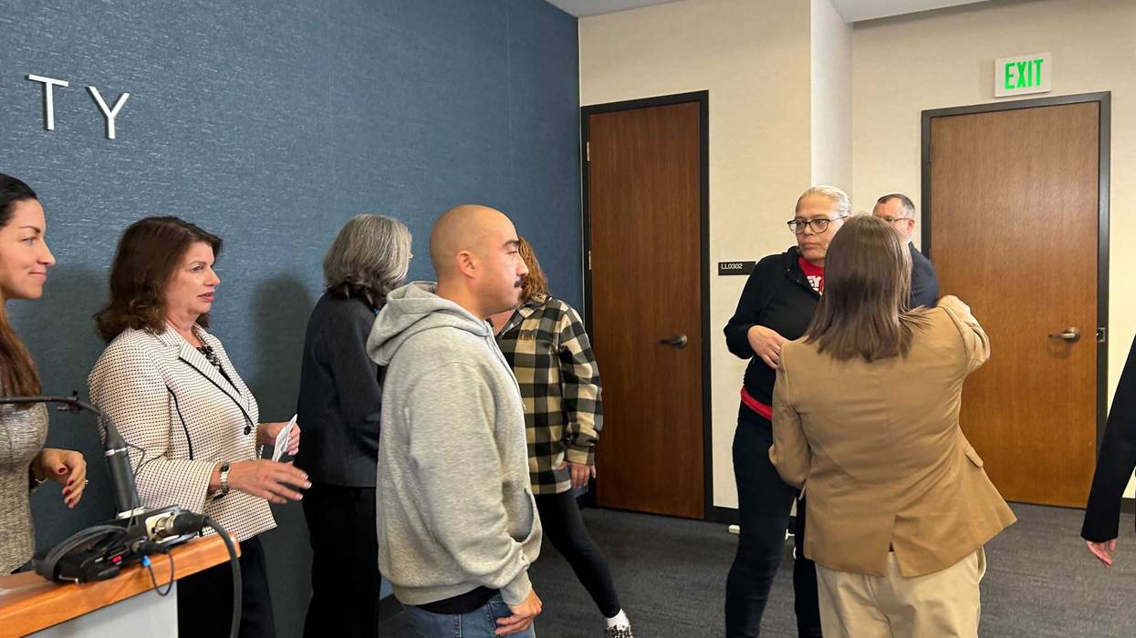 Edgar Barrientos-Quintana (center, hoodie) was previously charged with murder after a 2008 drive by shooting in Minneapolis that killed 18-year old Jesse Mickleson.