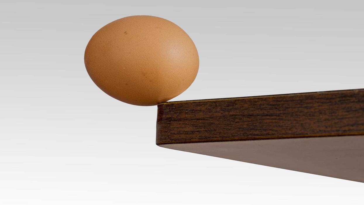 Egg on the edge of a table