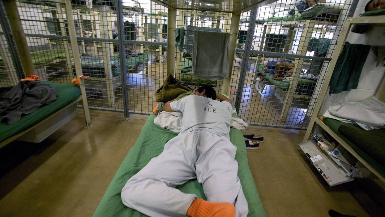EL CENTRO, CA - MARCH 1: A man sleeps in a dormitory for Mexican and foreign nationals convicted of a felony or deportable offense at a federal detention center on March 1, 2006 in El Centro, California. The federal issue of not having enough beds or detention centers is scheduled to be rectified in 2006 with increased Department of Homeland Security (DHS) funding. Mexican nationals caught illegally crossing the border by Customs and Border Protection (CBP) officers are sent back immediately if there is no outstanding criminal case on record. Those detained by Immigration and Customs Enforcement (ICE) following a criminal conviction are sent to detention centers like El Centro prior to their federal immigration court hearing. Many appeal the judgement to deport and stay at the El Centro facility until they win or lose. California was the first state in 1987 to implement a program where foreign nationals convicted of a crime were eligible for deportation. Many violators of immigration laws flee before their cases come to trial. It is estimated that some 6.3 million illegal Mexican immigrants live in the US and some 485,000 undocumented Mexican immigrants enter the US annually. The US government estimates 11 million illegal immigrants reside in the US In 2005, San Diego and Imperial counties of southern California deported 40,335 Mexican and Central American immigrants. (Photo by Robert Nickelsberg/Getty Images)