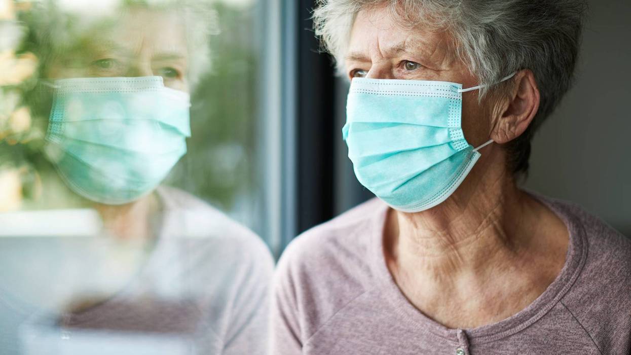 elderly person wears a face mask