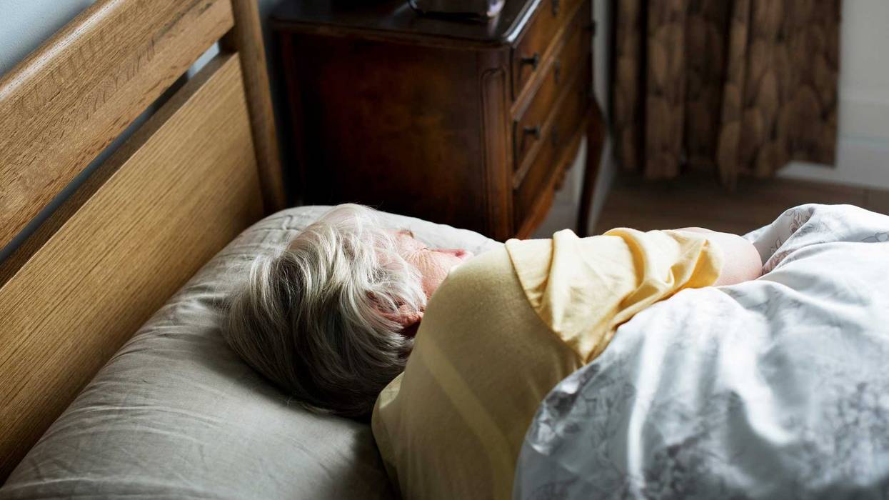 Elderly woman napping stock photo.