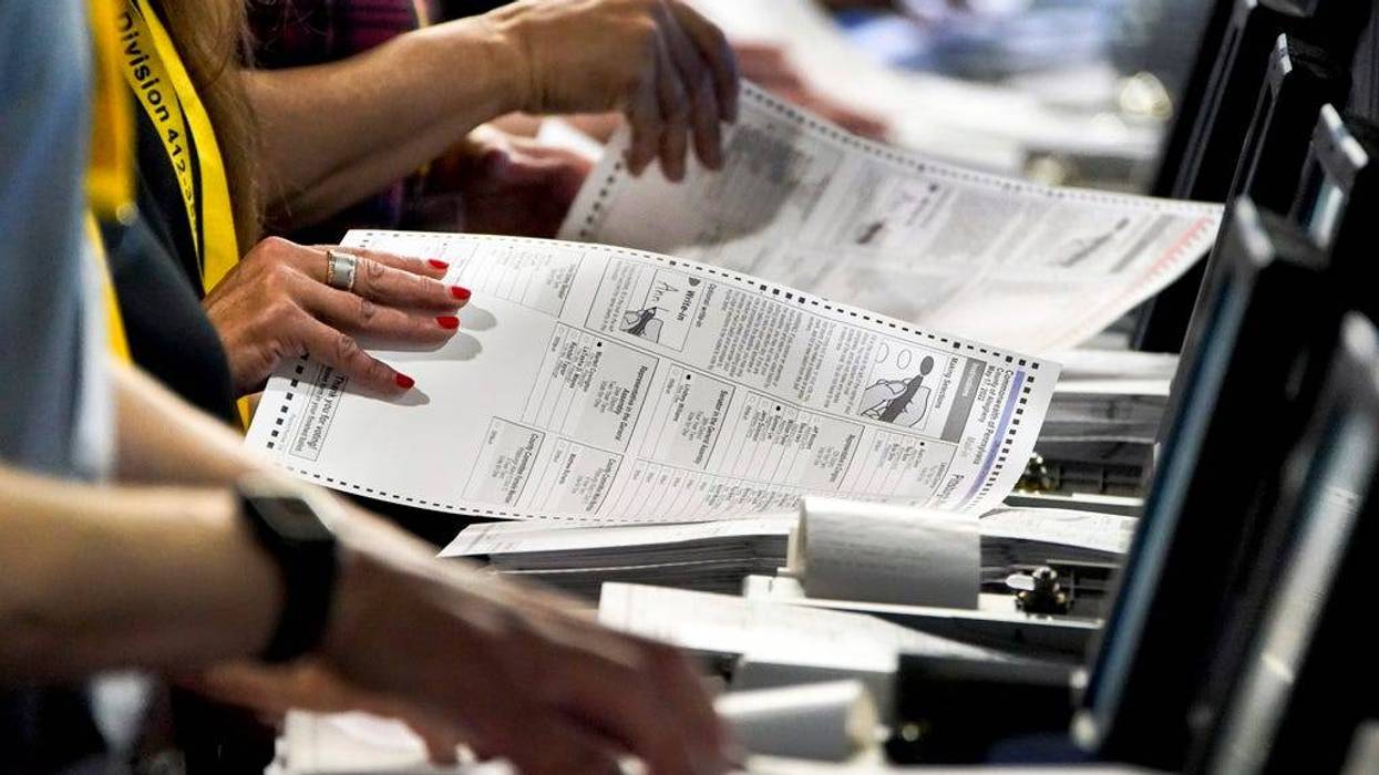 Election workers perform a recount of ballots from the recent Pennsylvania primary election at the Allegheny County Election Division warehouse in Pittsburgh on June 1, 2022.