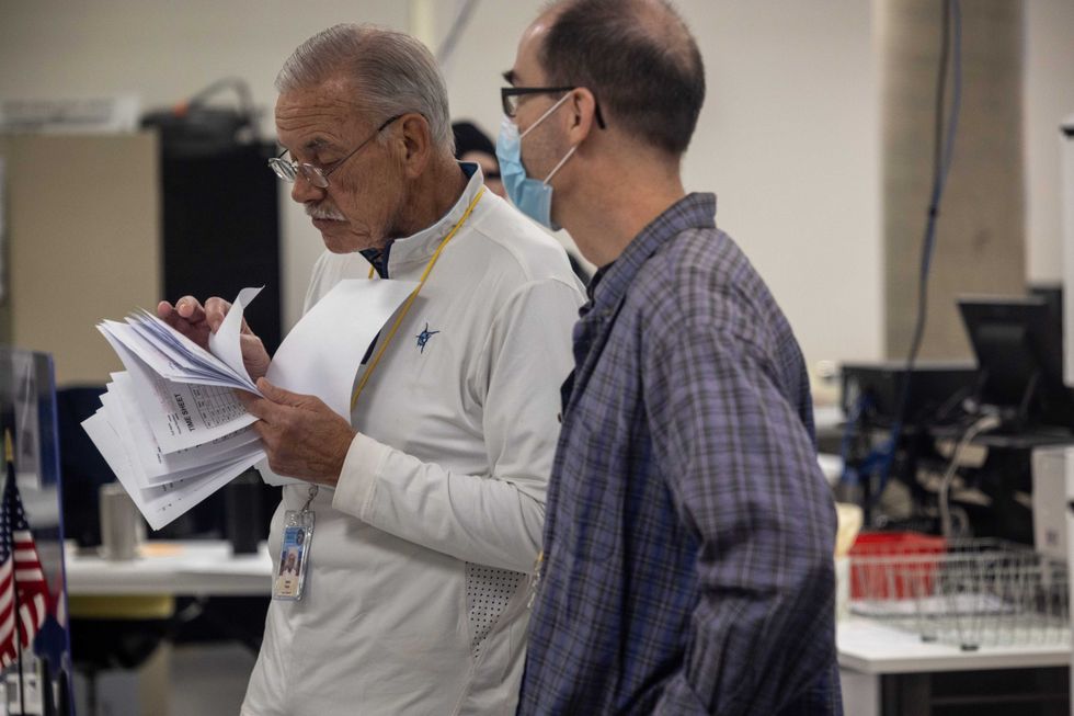 Election workers staff the Maricopa County Tabulation and Election Center on November 08, 2022 in Phoenix, Arizona. Bill Gates, Chairman of the Maricopa Board of Supervisors, said that about 20 percent of polling stations in the county have had tabulation machine malfunctions, where some ballots cannot be read. These ballots, he said, are being set aside for tabulation at the central election center in the evening after the polls close. After months of candidates campaigning, Americans are voting in the midterm elections to decide close races across the nation.