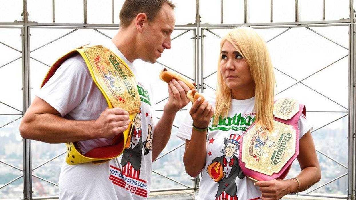 Eleven-time and defending men's champion Joey Chestnut, left, and defending women's champion Miki Sudo pose together during Nathan's Famous international Fourth of July hot dog eating contest weigh-in at the Empire State Building on Wednesday, July 3, 201
