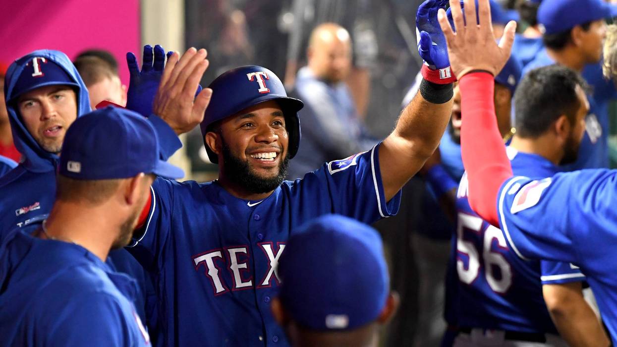 Elvis Andrus #1 of the Texas Rangers is greeted in the dugout after scoring a run in the sixth inning against the Los Angeles Angels at Angel Stadium on Aug. 28, 2019, in Anaheim, California.