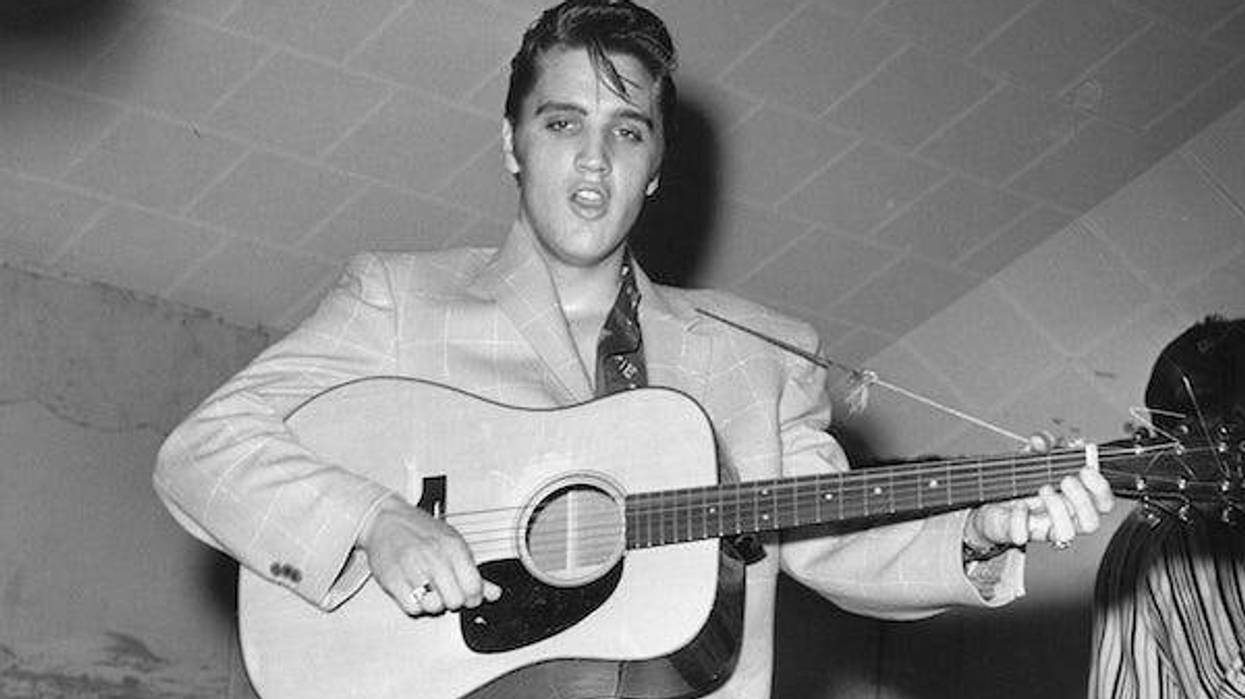 Elvis Presley plays guitar during a concert in Fort Worth, Texas, early in his career