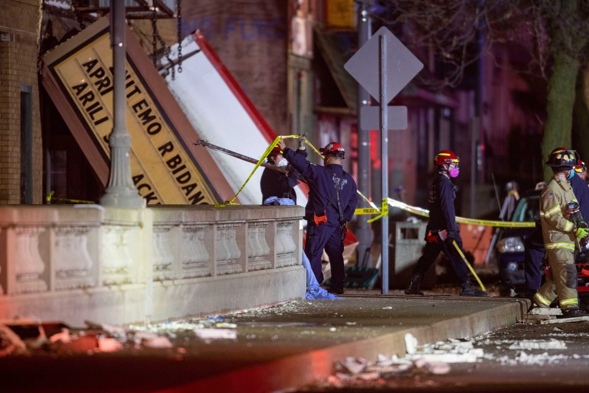 Emergency crew workers walk out of the Apollo Theater on Friday, March 31, 2023, in Belvidere. The theater's roof collapsed during a severe storm, killing one person and injuring 28. RFD Apollo Theater