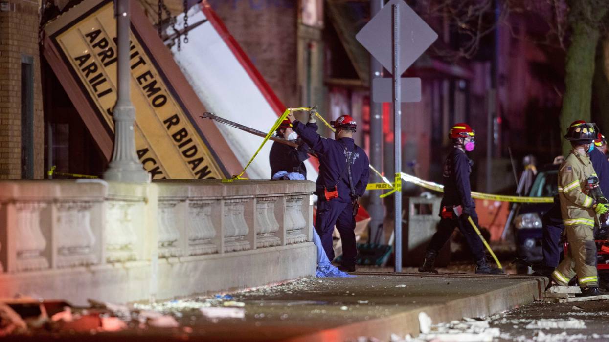 Emergency crew workers walk out of the Apollo Theater on Friday, March 31, 2023, in Belvidere. The theater's roof collapsed during a severe storm, killing one person and injuring 28. RFD Apollo Theater
