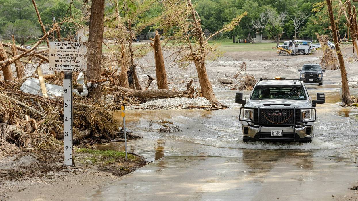 Emergency crews drive through flood waters searching for victims