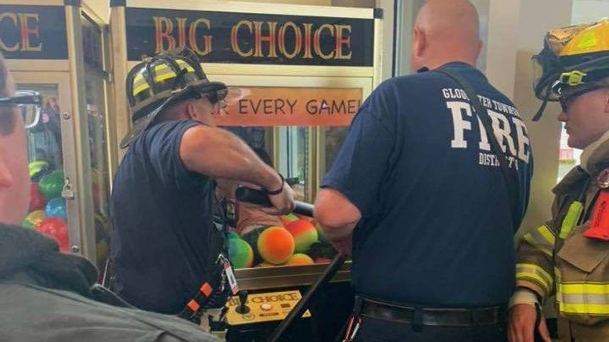 Emergency crews rescue a child from a game at the Gloucester Premium Outlets in Blackwood, N.J.