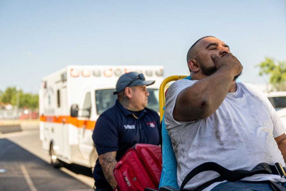 Emergency Medical Technician Omar Amezcua attends to a person after he called in for chest pain on June 29, 2023 in Eagle Pass, Texas. The patient called in reporting chest pain after working outside for hours. Maverick County Law Enforcement and paramedics are responding to larger volumes of medical-related calls as temperatures soar across the region. Extreme temperatures across the state have prompted the National Weather Service to issue excessive heat warnings and heat advisories that affect more than 40 million people. The southwestern region of the state has suffered record-breaking 120-degree heat indexes in recent days, with forecasters expecting more of the same. (Photo by Brandon Bell/Getty Images)