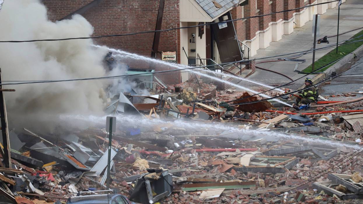 Emergency personnel work at the site of a deadly explosion at a chocolate factory in West Reading, Pa.