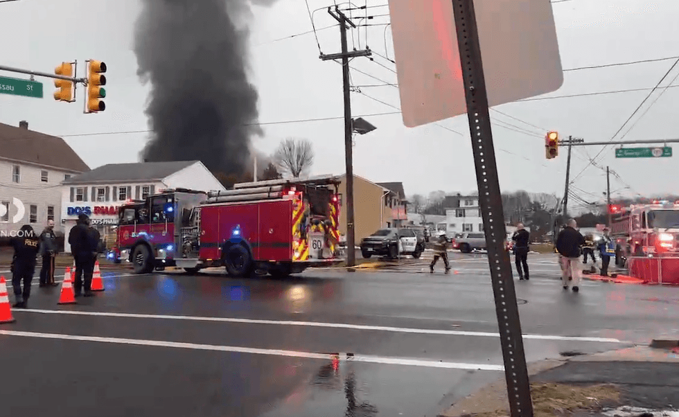 Emergency responders assist at the scene of a mattress fire in New Brunswick on Wednesday.