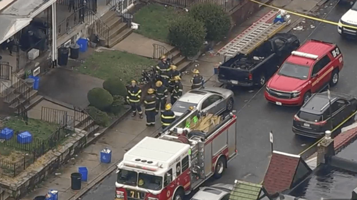 Emergency responders at the Mayfair row home where a woman, her baby and another man were found unconscious amid a large amount of suspected fentanyl