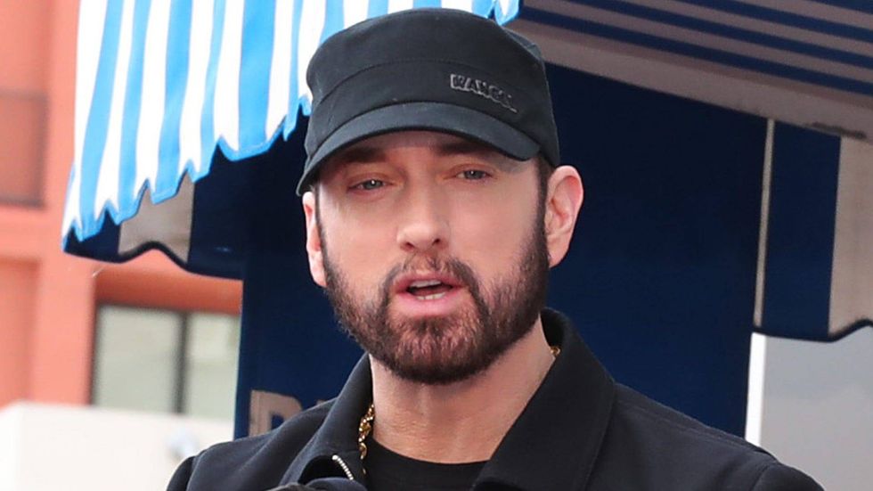 Eminem takes a break from promoting the death of Slim Shady to dance with his daughter at her wedding