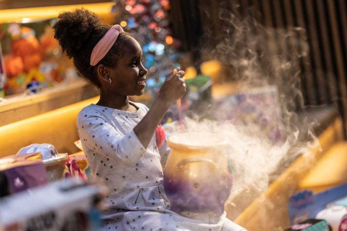 Emmie Chege, 8, poses with a 'Magic Mixies Couldron', one of this years 'top 12' Christmas toys, on November 02, 2021 in London, England. The DreamToys list, assembled by a panel of retailers and industry experts, attempts to predict the most sought-after toys within the UK ahead of Christmas. Given supply-chain disruptions, many UK retailers are anxious about their ability to keep popular items in stock. (Photo by Dan Kitwood/Getty Images)