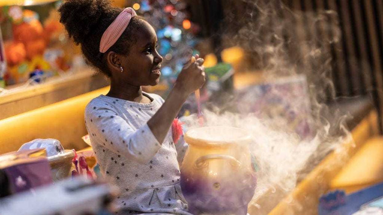 Emmie Chege, 8, poses with a 'Magic Mixies Couldron', one of this years 'top 12' Christmas toys, on November 02, 2021 in London, England. The DreamToys list, assembled by a panel of retailers and industry experts, attempts to predict the most sought-after toys within the UK ahead of Christmas. Given supply-chain disruptions, many UK retailers are anxious about their ability to keep popular items in stock. (Photo by Dan Kitwood/Getty Images)