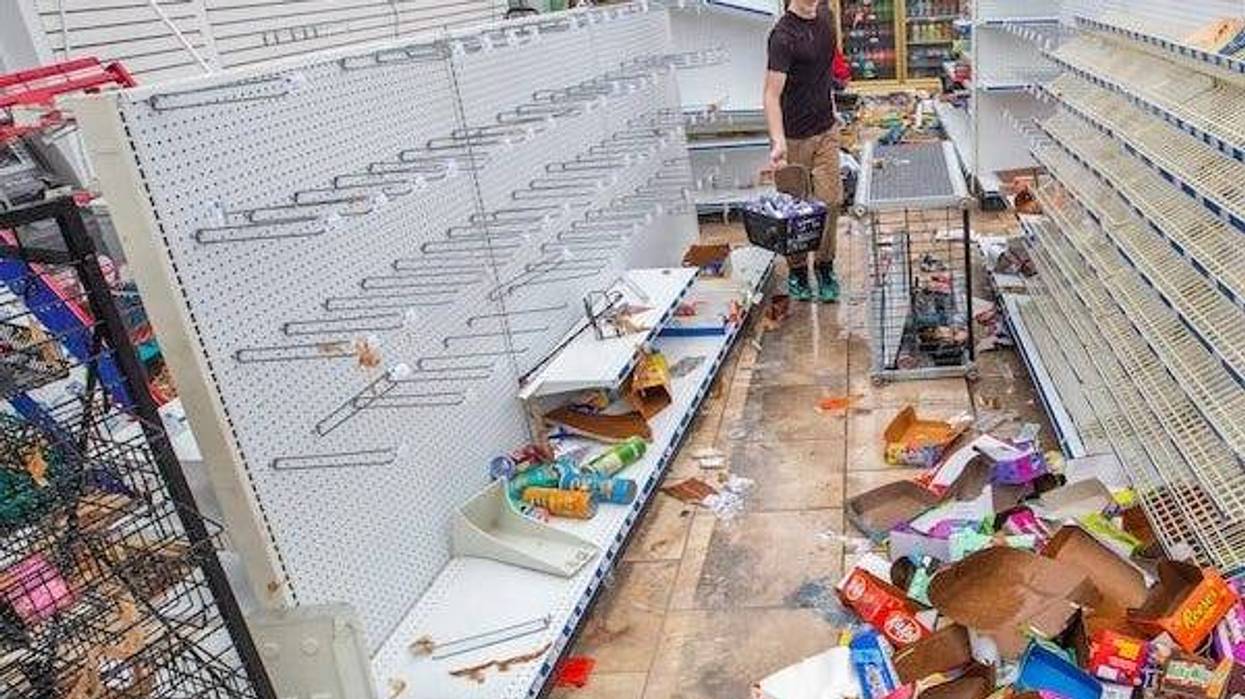 Employees work to remove stock from shelves and coolers at the Blu Convenient Store in Panama City Beach