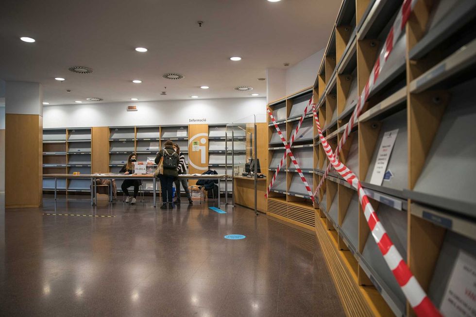 Empty bookshelves are seen in the electoral college of the Jaume Fuster Library during Catalonia