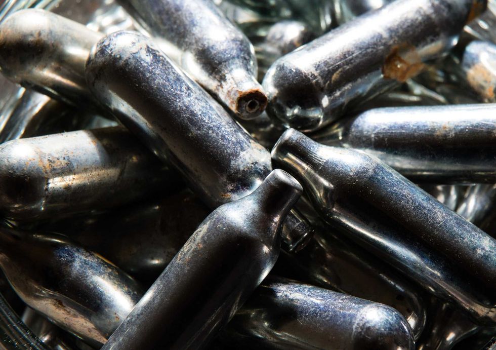 Empty chargers for reusable whipped cream cannisters. Colloquially referred to as "whip-its," the cannisters contain nitrous oxide and are used as an inhalant.