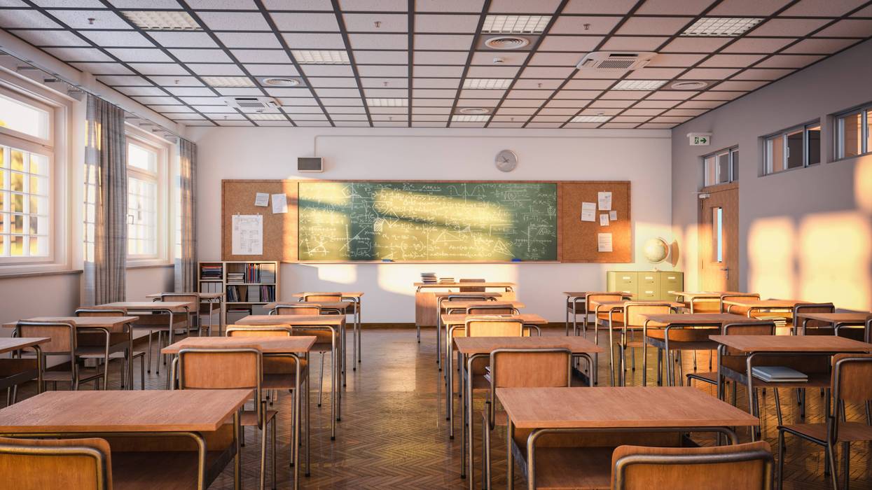 empty classroom with desks and blackboard stock photo