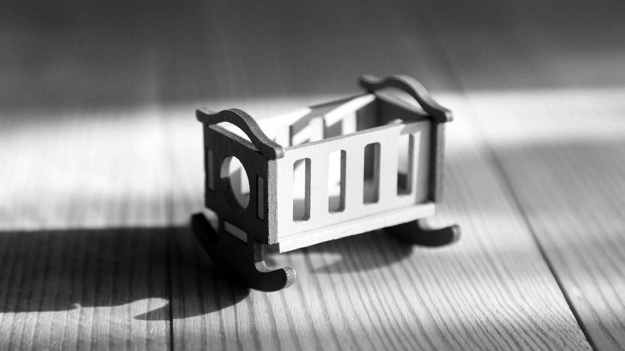 empty crib toy. Black and white.