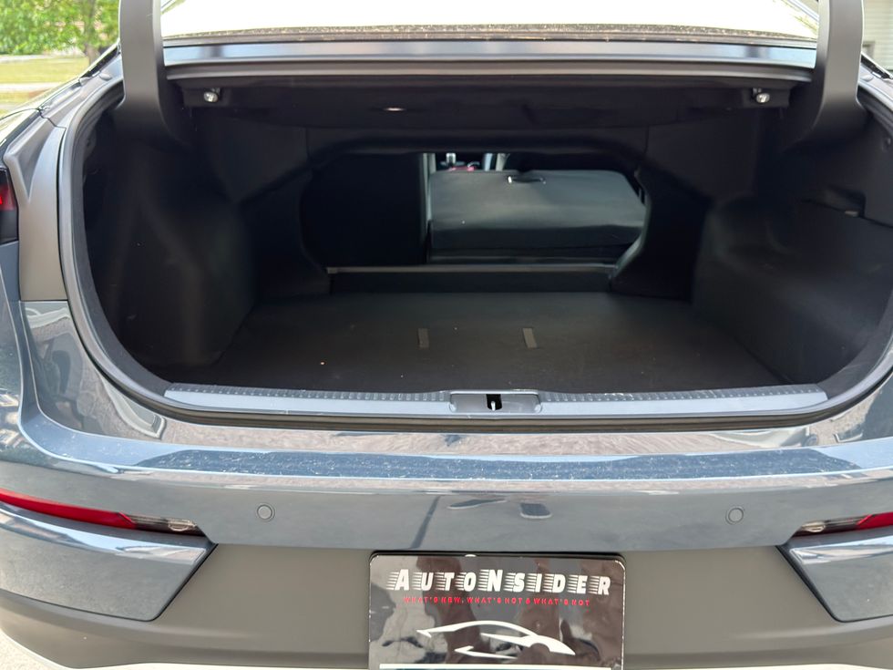 Empty gray car trunk with rear seats folded down.