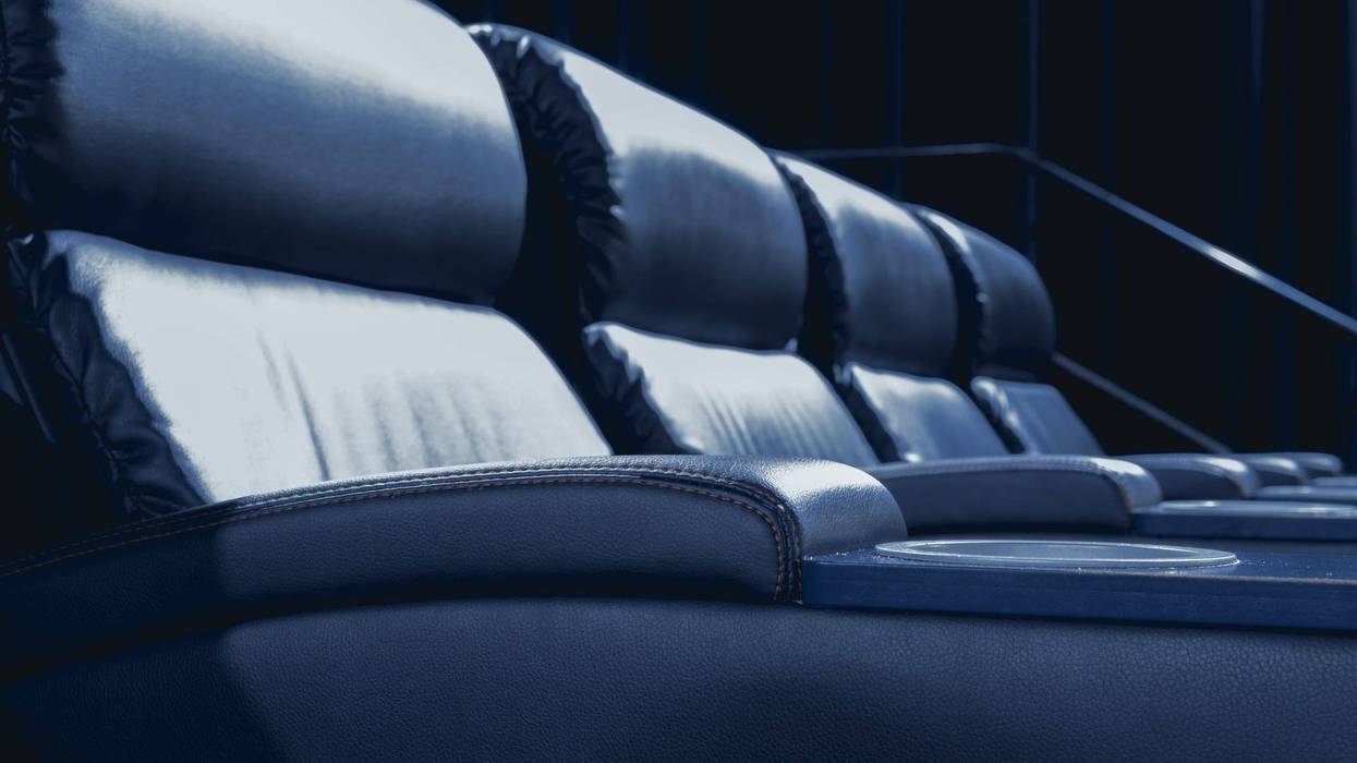 Empty modern cinema with recliner leather seat.