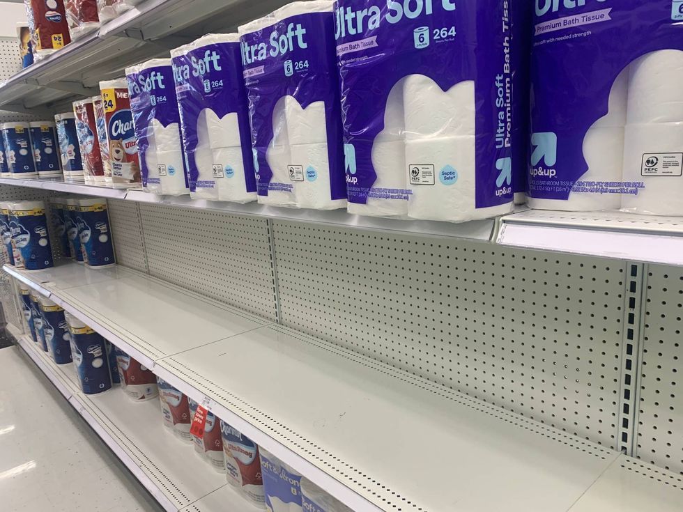 empty shelves in the paper goods section